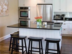 Kitchen island countertop and stools placed around it