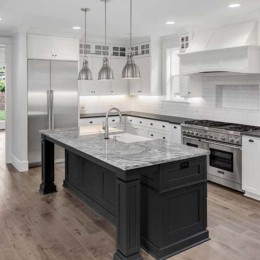 Kitchen with wooden flooring, stainless steel appliances, and finished countertops | MTP Construction